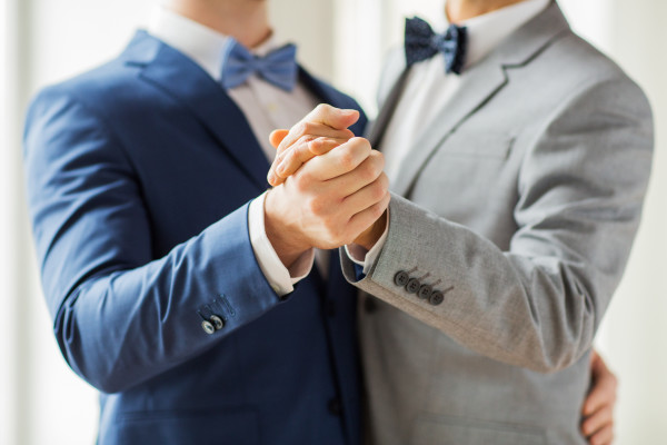 close up of happy male gay couple dancing