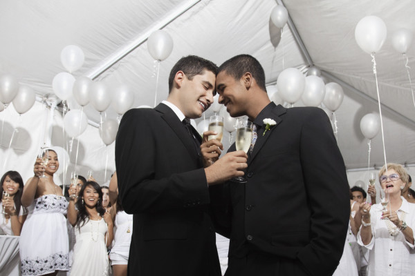 Gay married couple enjoying wedding reception